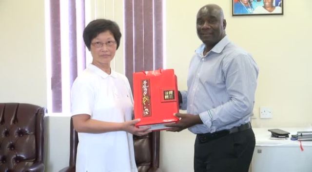 Minister of Agriculture on Nevis Hon. Alexis Jeffers presented with a gift from Crop Pest and Disease Control Specialist Tau-Mei Chou, a facilitator for the Pest and Disease Control and Soil Fertilisation Enrichment Workshop, hosted by the Republic of China (Taiwan) during a visit to his office on August 17, 2015